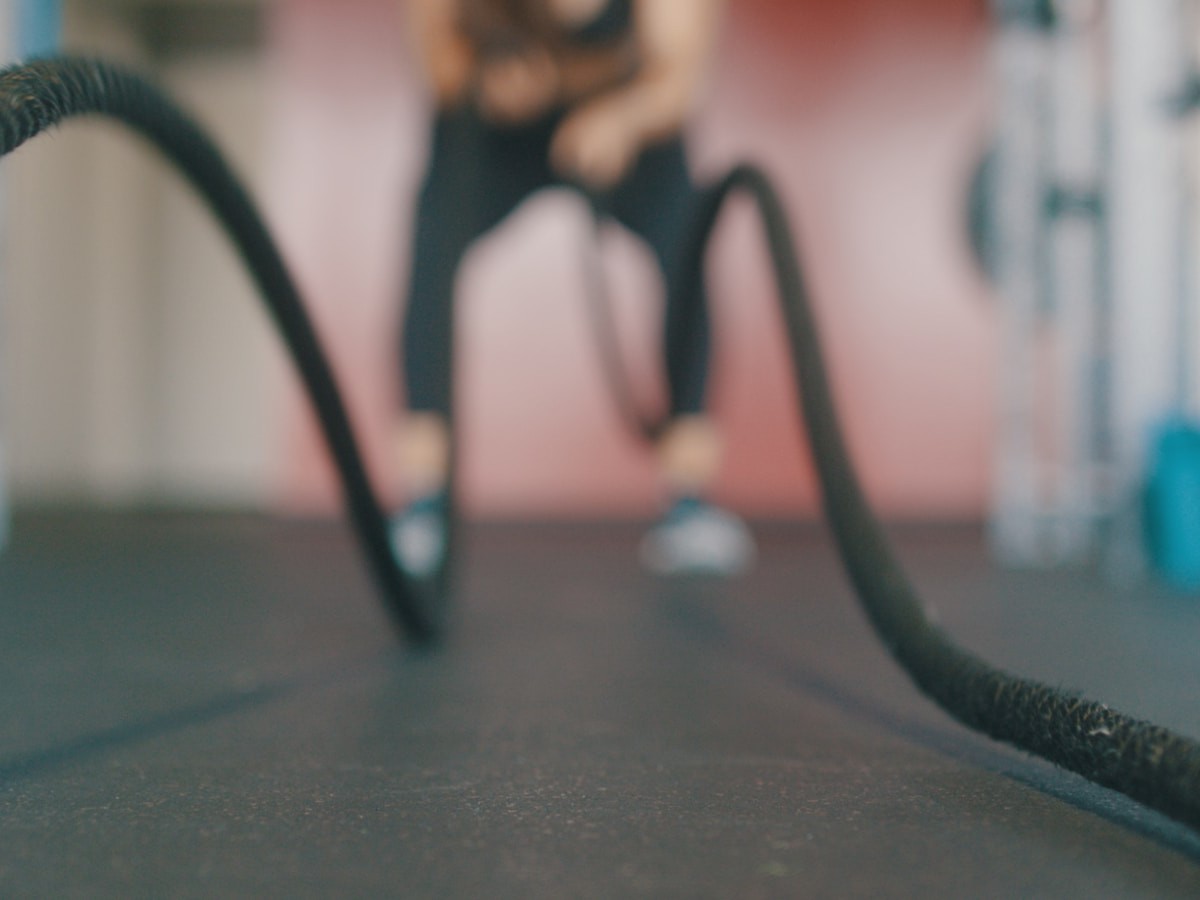 person holding black exercise rope